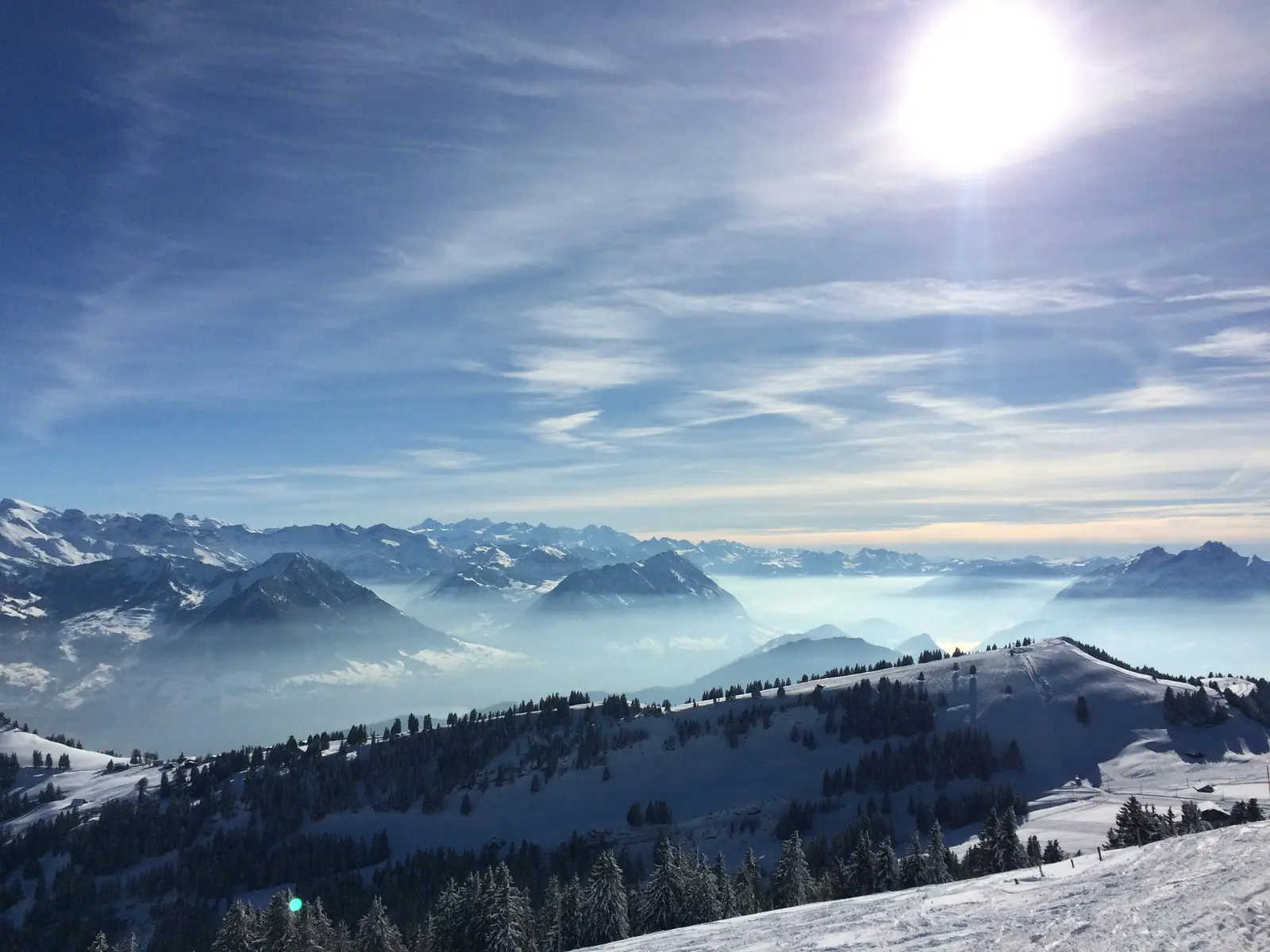 Morning fog over an Alpine valley, mountain ridges fading into the distance