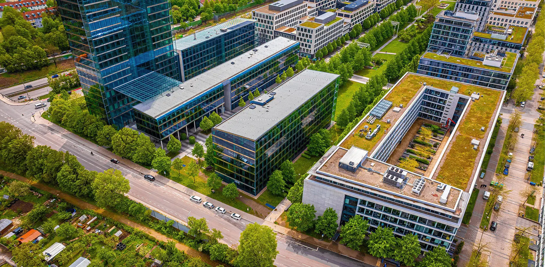 An office campus with green roofs and trees, seen from the air