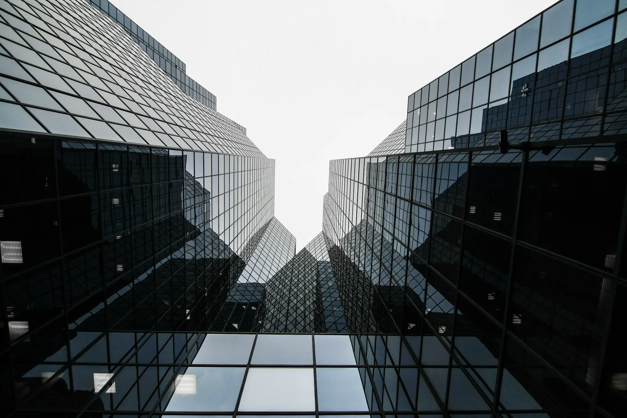 Looking up between two glass towers