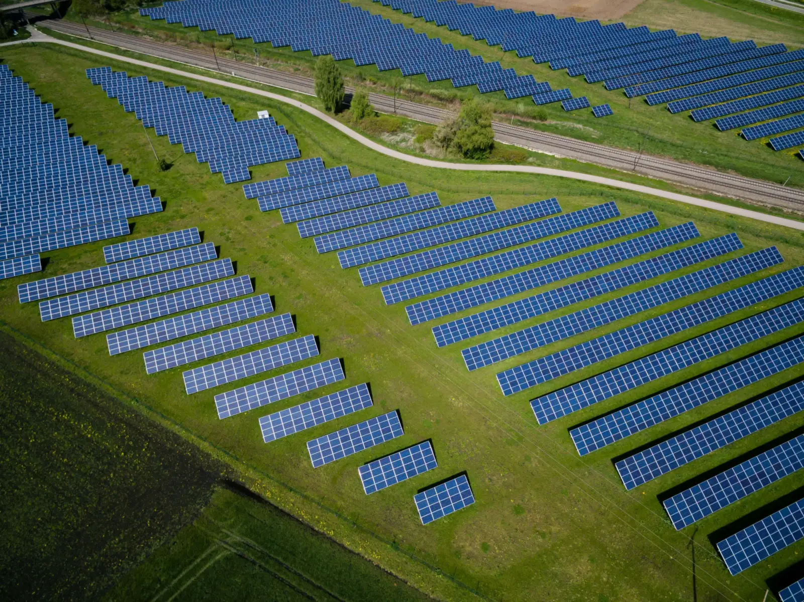 A solar park in green fields, seen from the air