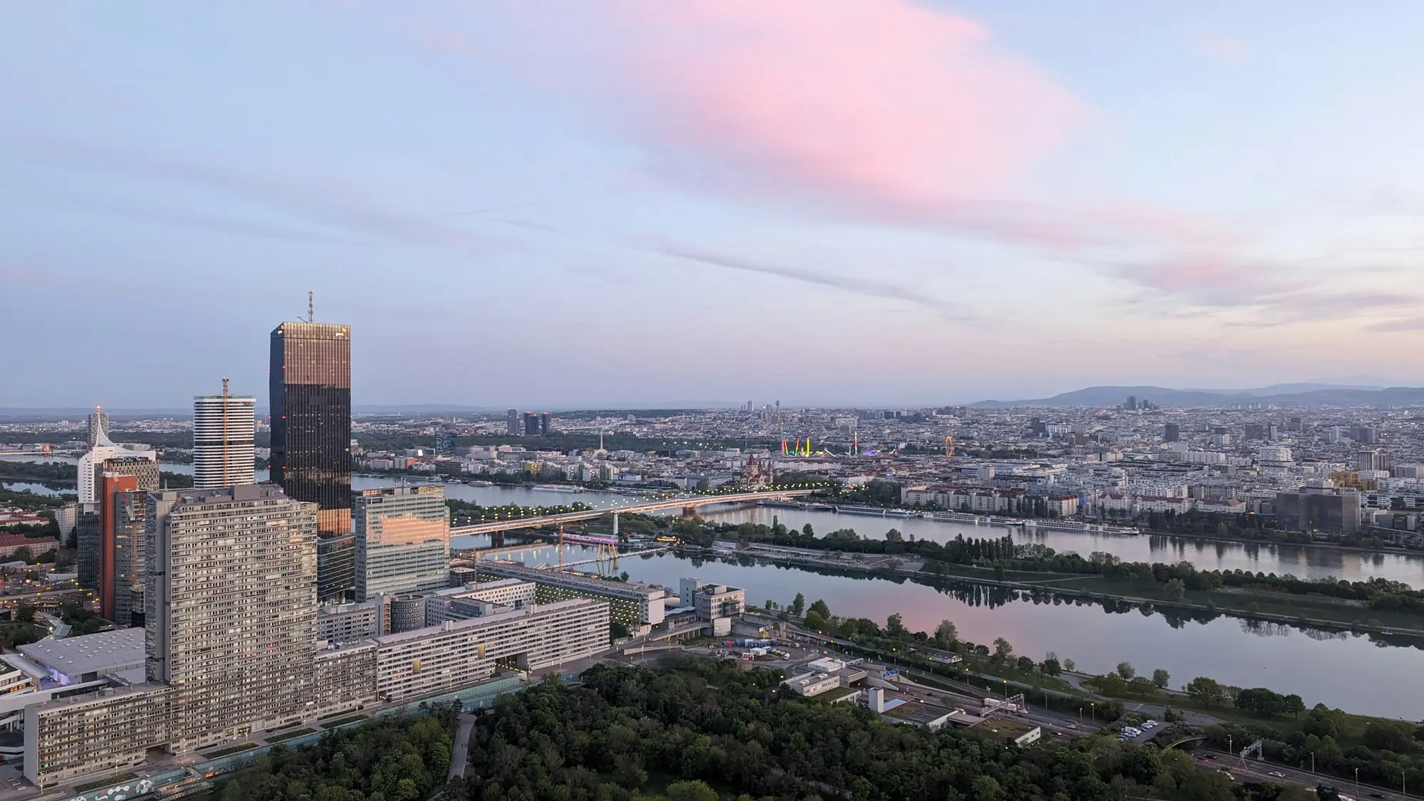 Vienna by the Danube at dusk, the city lights reflected in the water